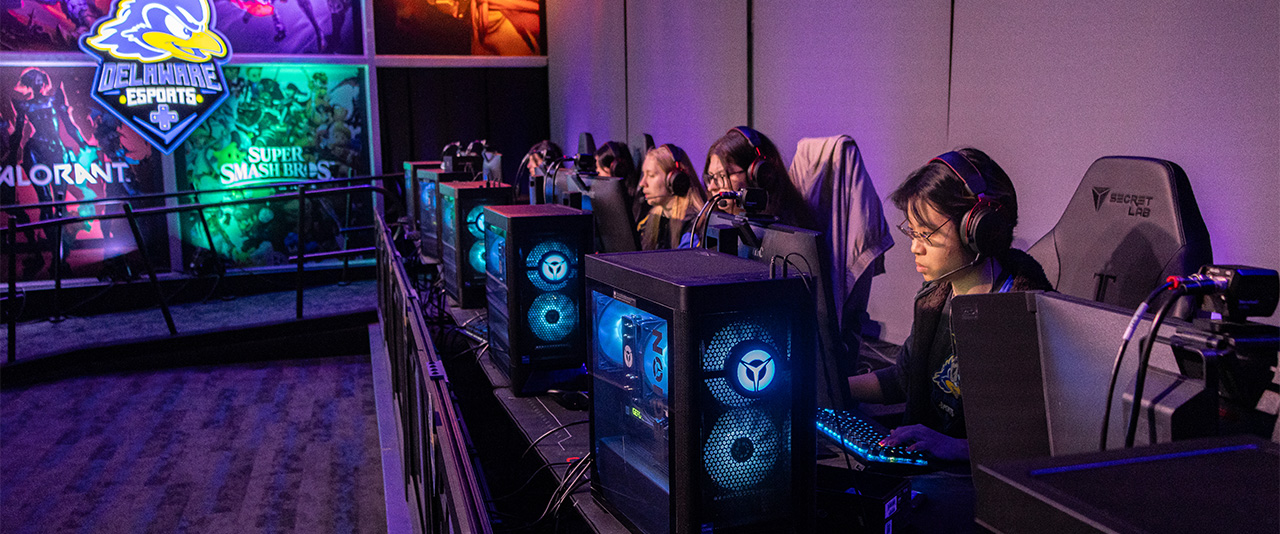 Varsity players compete on stage in the Esports Arena