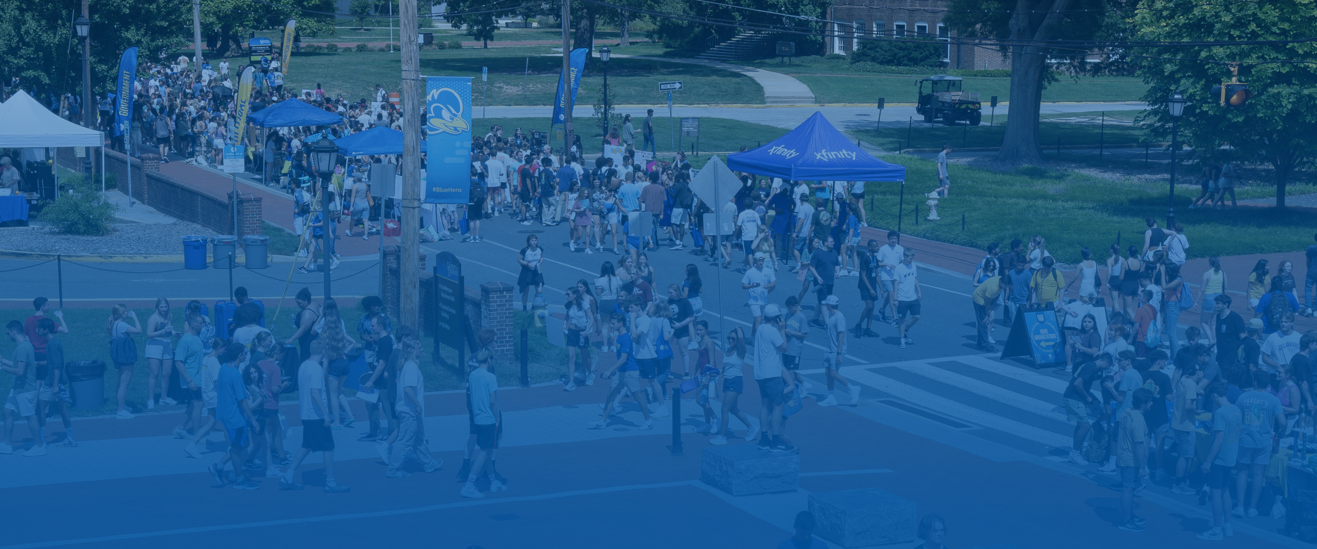 students gather at the various tables at the Involvement Fair on Academy Street