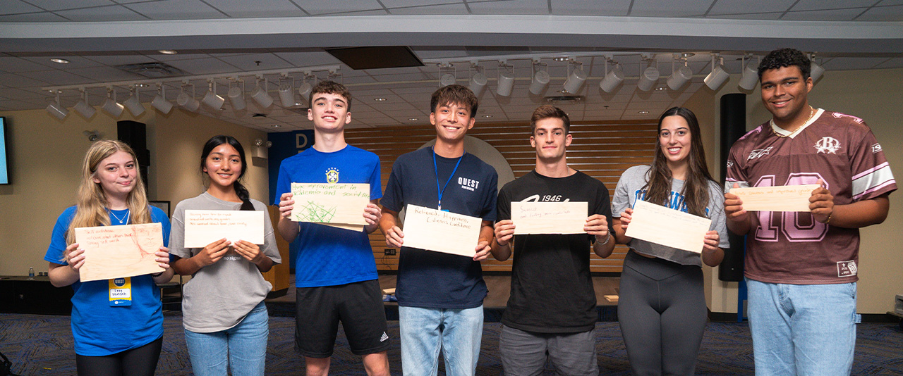 Students show broken wood blocks from a board-breaking exercise
