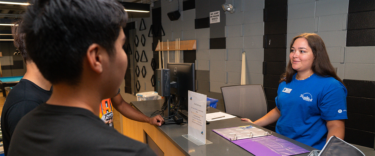 Hen Zone student associate speaking with two students