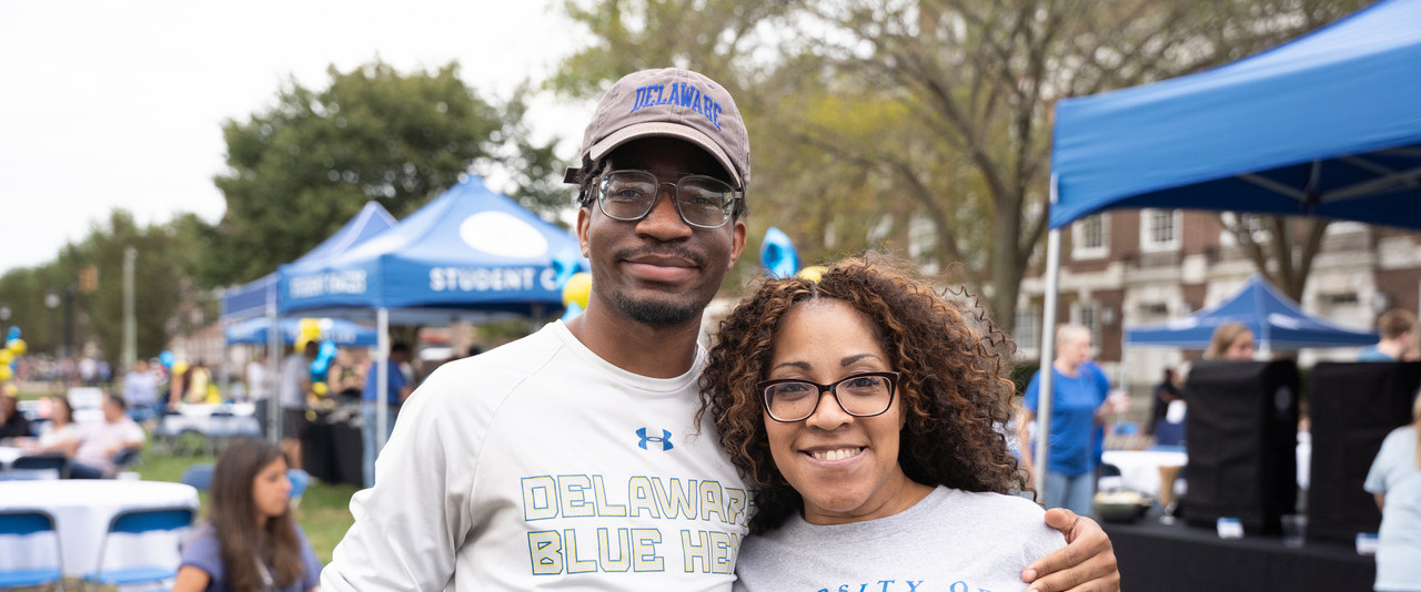 A family smiles for a photo at the 2023 Parents and Family Weekend Welcome Reception