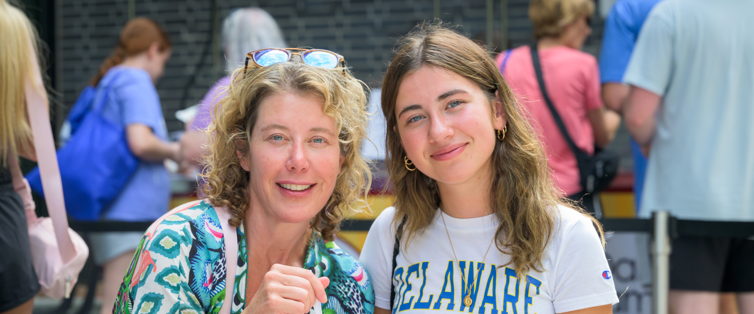 a student and her mother smile while eating ice cream at NSO