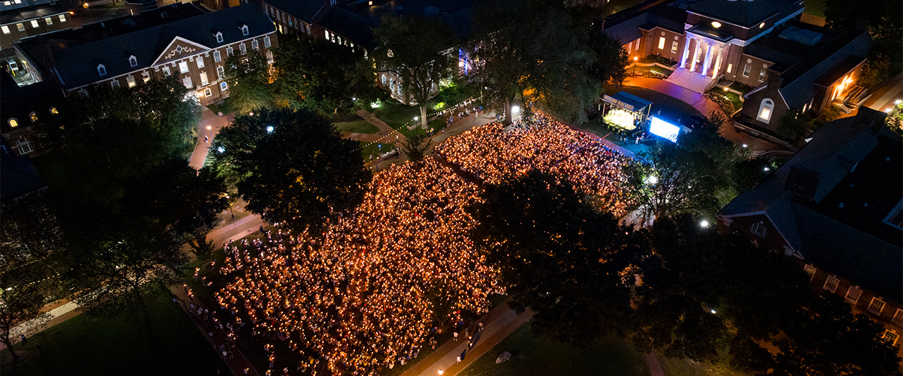 Candles light up The Green at the Twilight Induction Ceremony