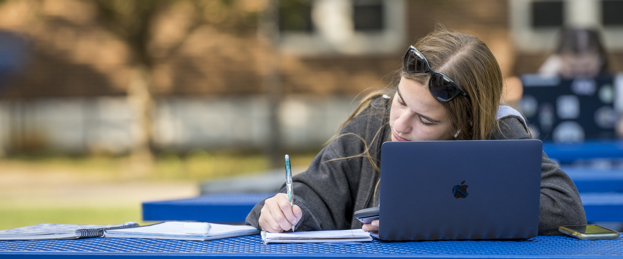 Student working outside on a laptop