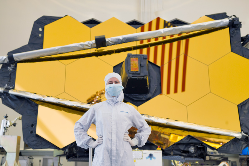 University of Delaware graduate Elaine Stewart is working with the contamination engineering team on the James Webb Space Telescope. The team has worked to ensure no particles, oils or molecules interfere with the proper operation of the telescope. She is wearing the required cleanroom garments in this photo taken at Northrop Grumman in Los Angeles.