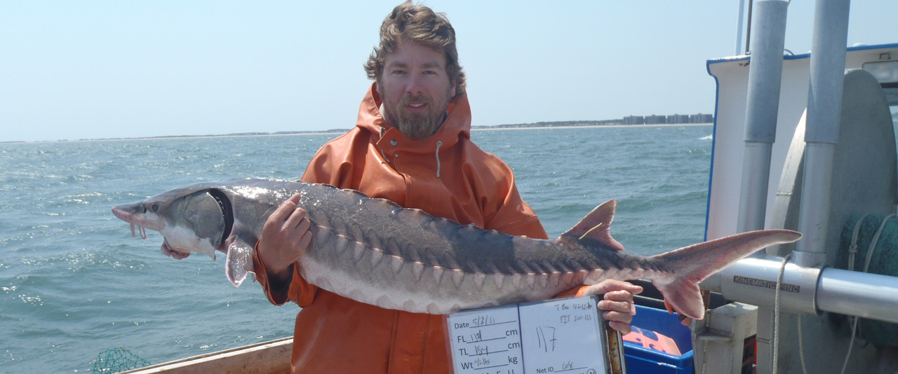 Matthew Breece holding a sturgeon