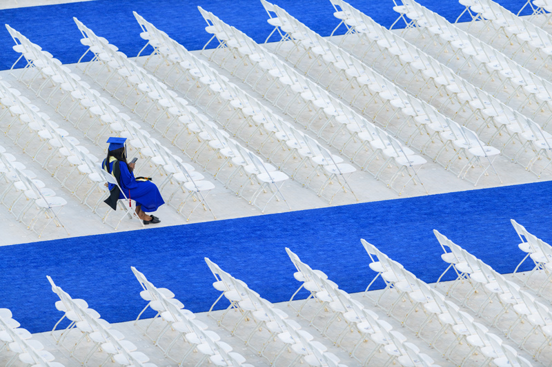 A graduate awaits the start of the Commencement ceremony on Saturday, May 28.