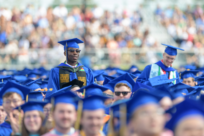 Graduates stand to be recognized during the Commencement ceremony.