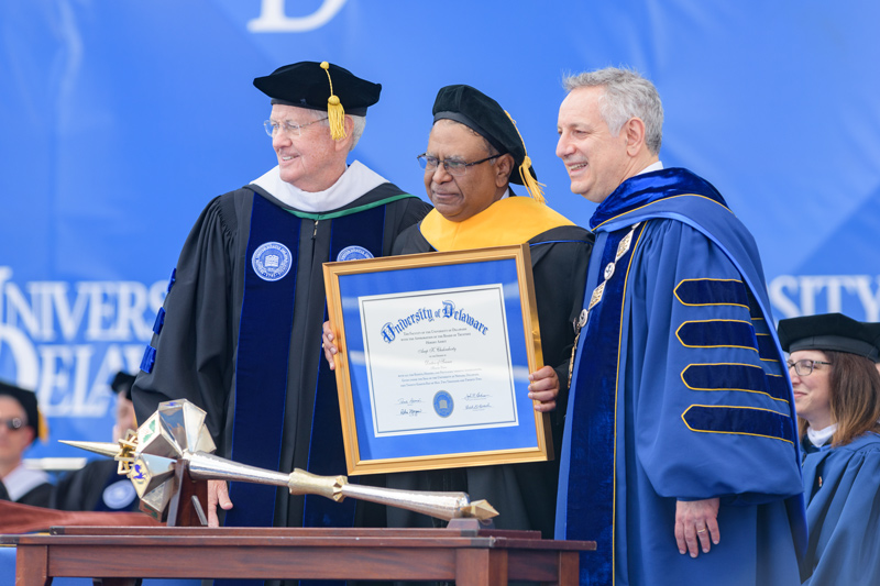 Arup K. Chakraborty, alumnus and director of the Institute for Medical Engineering and Science and Institute Professor at the Massachusetts Institute of Technology, is recognized with an honorary degree, the University’s highest accolade. Chakraborty is pictured with John Cochran, Chairman of the Board of Trustees, and UD President Dennis Assanis.