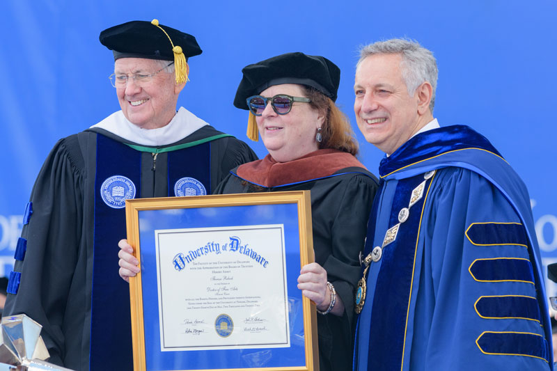 An Honorary Doctor of Fine Arts degree is presented to award-winning playwright Theresa Rebeck by Board Chair John Cochran and President Dennis Assanis.