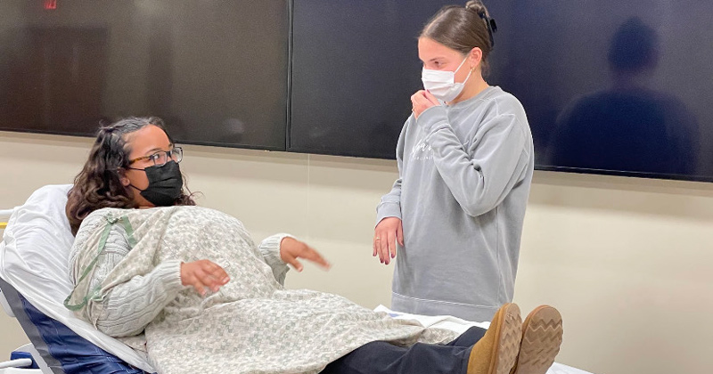 Allie Melchione, now a senior nursing major, obtained her Birth Companion Program Certificate in the spring of 2021. Here, she’s paired with fellow nursing major Johnna Garber, practicing calming techniques. 