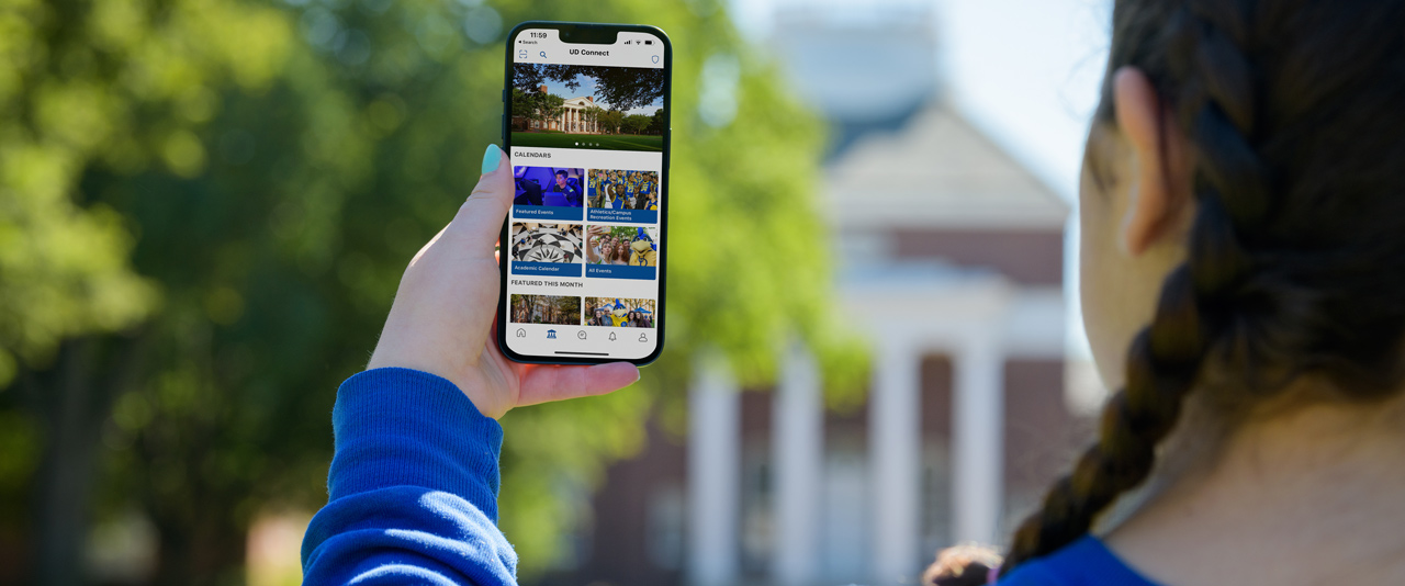 UD student holds up her phone, showing the new UD Connect app UD student holds up her phone, showing the new UD Connect app