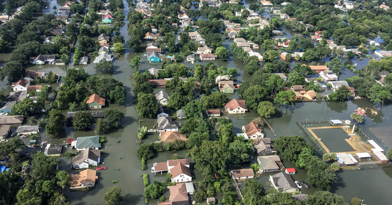 A photograph from a helicopter shows the flooding in a community.