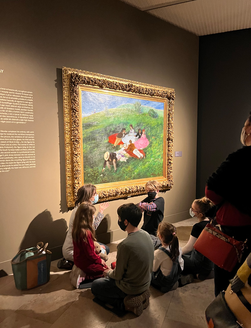 Life imitates art in Fiona Eramo’s “Criss Cross Applesauce” photo of a group of young children sitting and viewing a painting that emulates them. She studied abroad in Hungary in the 2022 Winter Session.