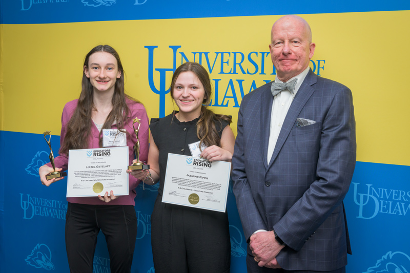 Jasmine Piper and Hazel Getzlaff of Cape Henlopen High School, award winners in the Children’s Literature, K-3 varsity category, accept their CEHD-sponsored award with CEHD Dean Gary T. Henry. 