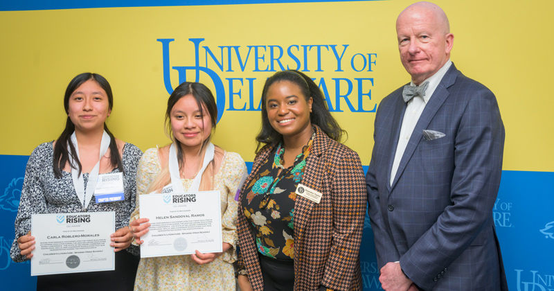 Carla Roblero-Morales and Helen Sandoval Ramos of Sussex Central High School, award winners in the Children’s Literature, Spanish varsity category, accept their CEHD-sponsored award with Deandra Taylor, academic program manager for CEHD’s Teachers of Tomorrow program in UD’s Center for Excellence and Equity in Teacher Preparation, and Gary T. Henry, dean of CEHD.