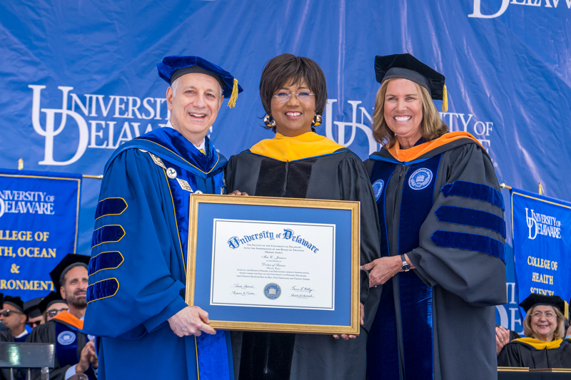 Commencement speaker Dr. Mae Jemison, a former NASA astronaut and the first African American woman in space, receives an honorary doctorate of science degree from UD President Dennis Assanis and Board Chair Terri L. Kelly.