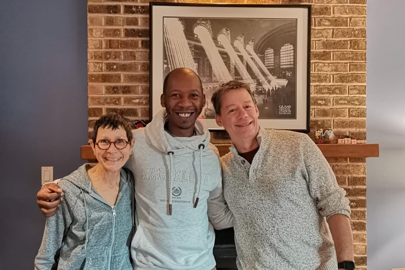 Paul Head and his wife, Carol, pose with Sabelo Mthembu, an award-winning conductor from South Africa who visited UD last spring to share his choral tradition with the School of Music.