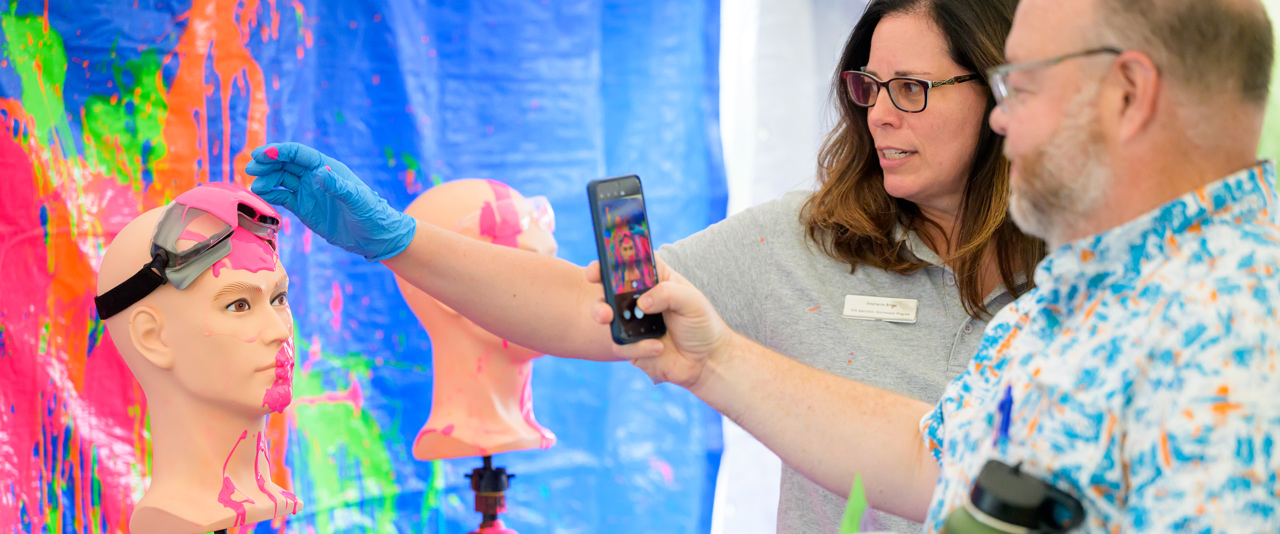 nteractive demonstrations like paint throwing helped participants in the Ammon Pinizzotto Biopharmaceutical Center safety retreat held on Sept. 20 understand first-hand the protective capabilities of gear like safety glasses in an emergency.