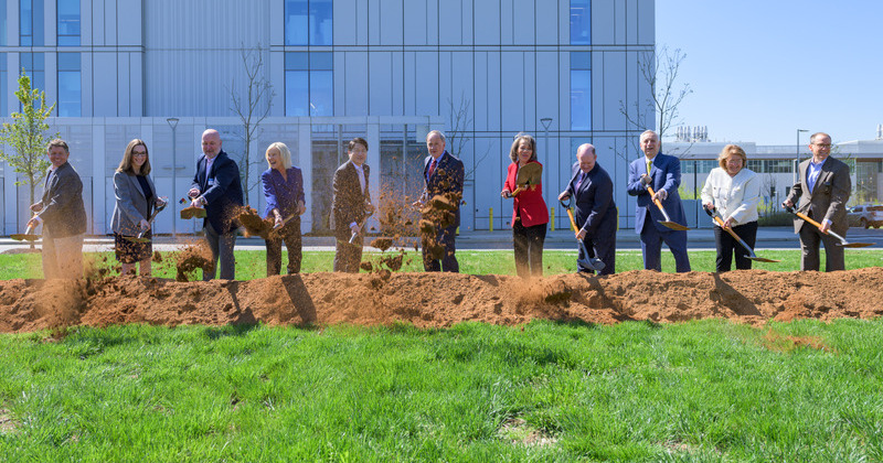 a group of people with shovels at a ground breaking event