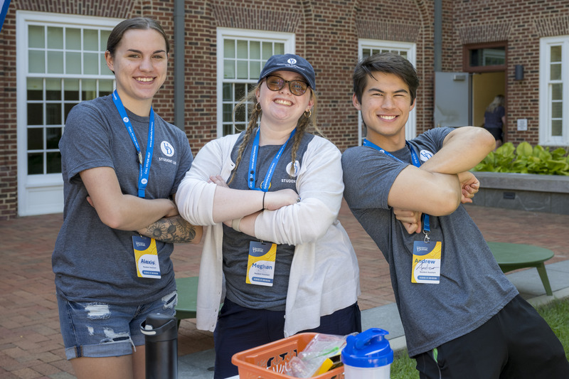 Three resident assistants from South Academy Hall — senior nutrition and dietetics major Alexis Adkins, sophomore international relations and public policy major Meghan Rydell, and junior elementary education major Andrew Sprouse — offer help at the engagement table during Move-In Weekend.
