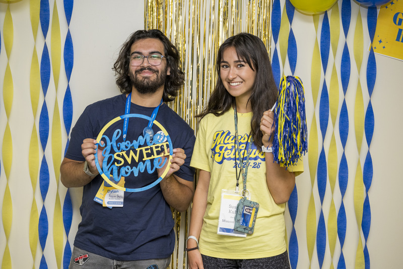 Resident assistant Dylan Keegan and second-year student and Munson Fellow Susan Kuhn pose at the photobooth in Redding Hall during Move-In Weekend.