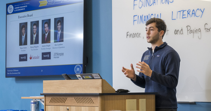 Alex Lambros, a senior majoring in financial planning and wealth management, presents to teachers during a session in November. 