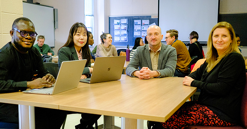 From left, doctoral students John Oluwadero and Hojung Lee meet with School of Education professor Kenneth A. Shores and Laura Desimone, the L. Sandra and Bruce L. Hammonds Professor in Teacher Education and director of research in the College of Education and Human Development. Desimone is director of the Graduate College’s interdisciplinary education and social policy doctoral program.