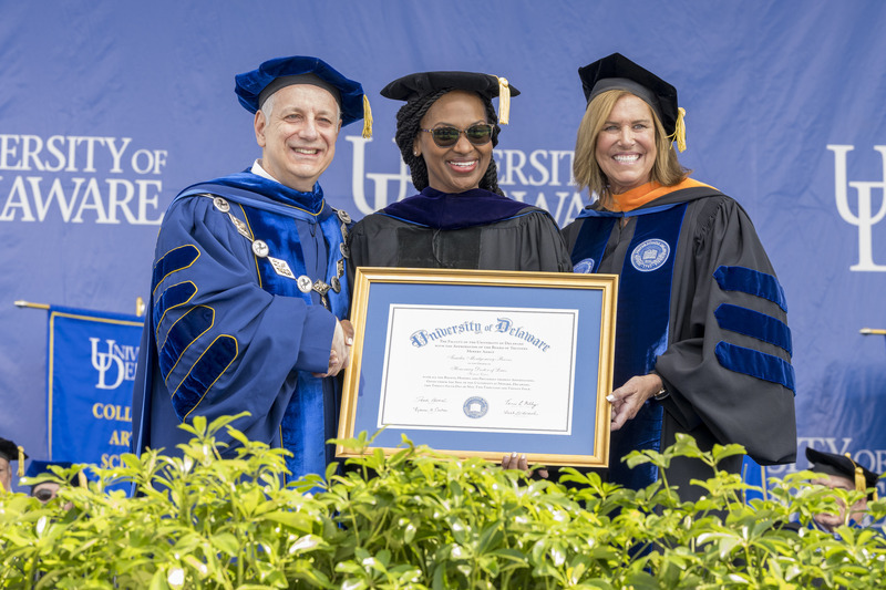 UD President Dennis Assanis (left) and Board Chair Terri L. Kelly (right) awarded an honorary doctor of laws degree to Tamika R. Montgomery-Reeves, the first African-American person from Delaware to serve as judge on the United States Court of Appeals for the Third Circuit.