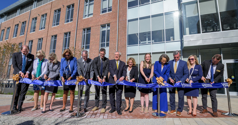 University of Delaware officials join with faculty, elected officials and a graduate student to cut the proverbial ribbon