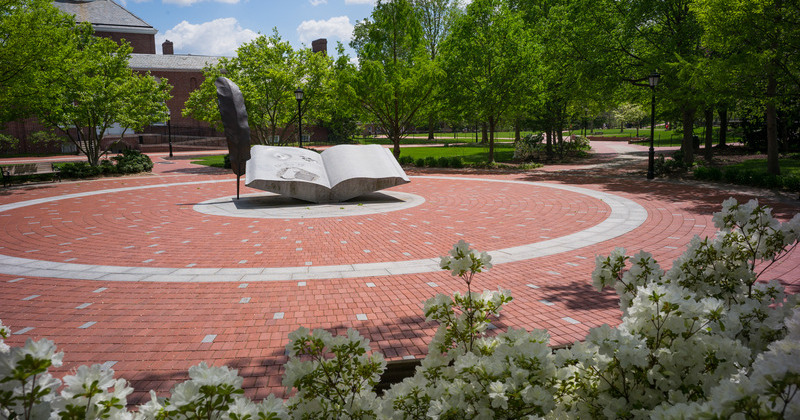 Statue of open book on UD campus