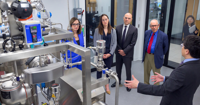 Kelvin Lee, director of the National Institute for Innovation in Manufacturing Biopharmaceuticals (NIIMBL), explains features of a NIIMBL lab during a tour with U.S. Rep. Sarah McBride and members of the National Security Commission on Emerging Biotechnology, including Vice Chair Michelle Rozon, Paul Arcangeli and Dov Zakheim.