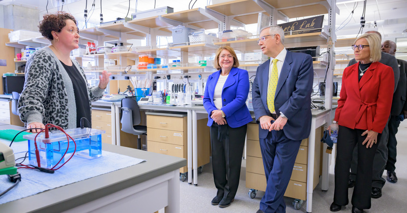 Tania Roth (left) showing a lab to President Dennis Assanis and others