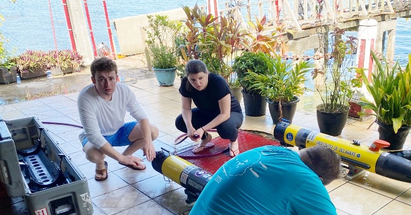 Stephen Maister (left) was one of eight UD students who spent last month looking for downed planes and MIAs from World War II in Micronesia as interns with Project Recover. He and fellow UD student Lauren Koch help clean the autonomous underwater vehicles that map the seafloor.