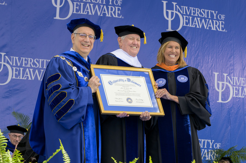 UD President Dennis Assanis (left) and Board Chair Terri L. Kelly (right) awarded an honorary doctor of humane letters degree to John R. Cochran III, former chair and current member of the University of Delaware Board of Trustees.