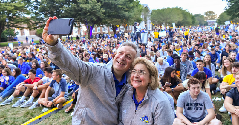 President Assanis and Mrs. Assanis take a selfie with incoming first year students during the Twilight Induction Ceremony in 2019.