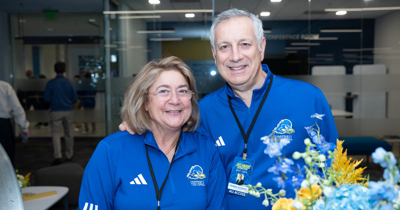 President Assanis and Mrs. Assanis at a tailgate before a Delaware football game. 
