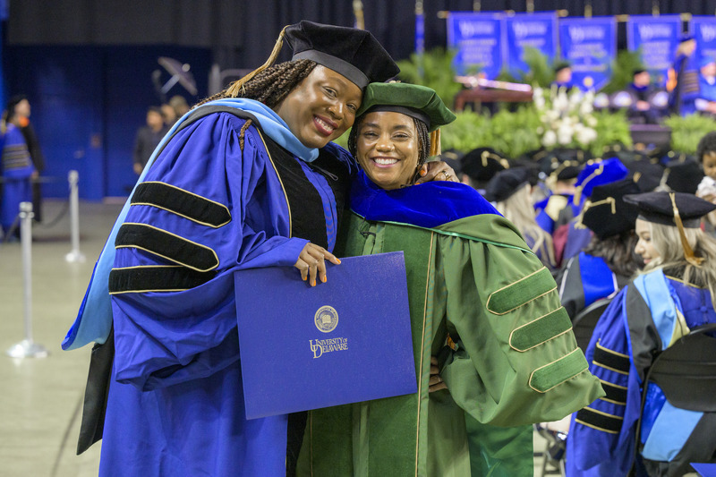 The University of Delaware’s May 2025 Doctoral Hooding Ceremony honored about 230 students, including Sophia Vilceus (left), who was hooded by Kisha Porcher.