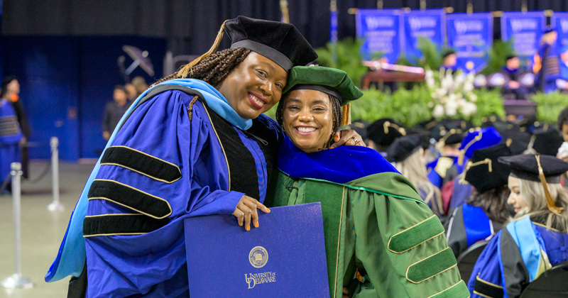The University of Delaware’s May 2025 Doctoral Hooding Ceremony honored about 230 students, including Sophia Vilceus (left), who was hooded by Kisha Porcher. 