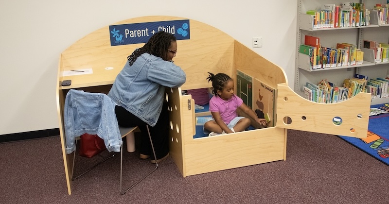 Maisha Carey and her daughter use the parent-child carrel in Morris Library’s newly opened Family Study Space. 