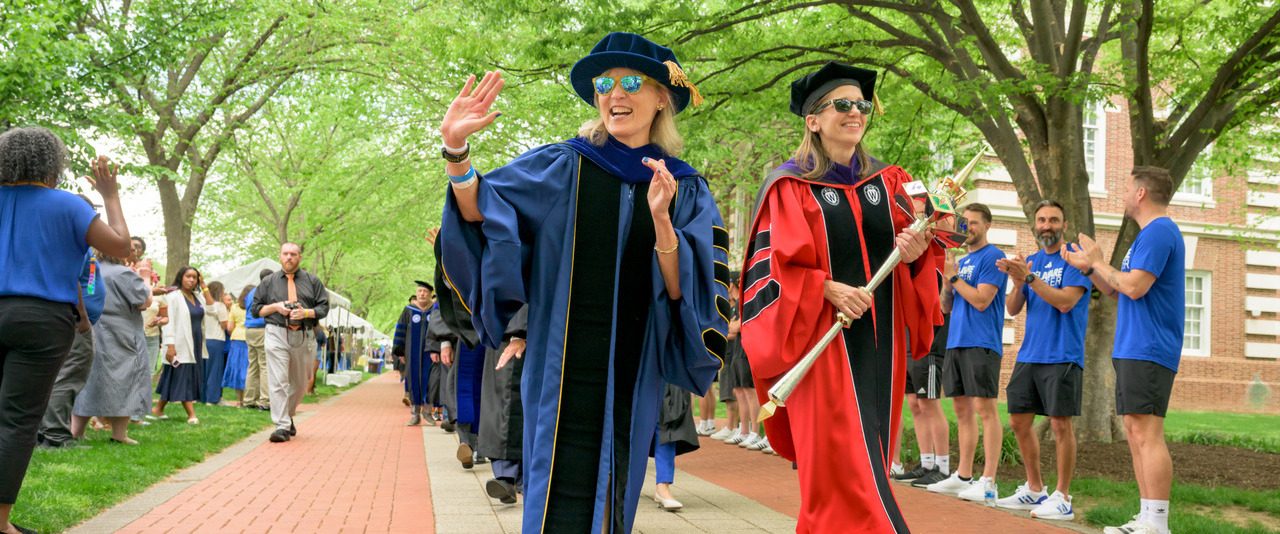 Laura Carlson was formally inaugurated as the University of Delaware’s 29th president in a tradition-filled ceremony on The Green on Friday, April 17. Angela Downin (right), vice president, general counsel and university secretary, carries the University’s mace, a symbol of power and authority that signifies the dignity of an institution.