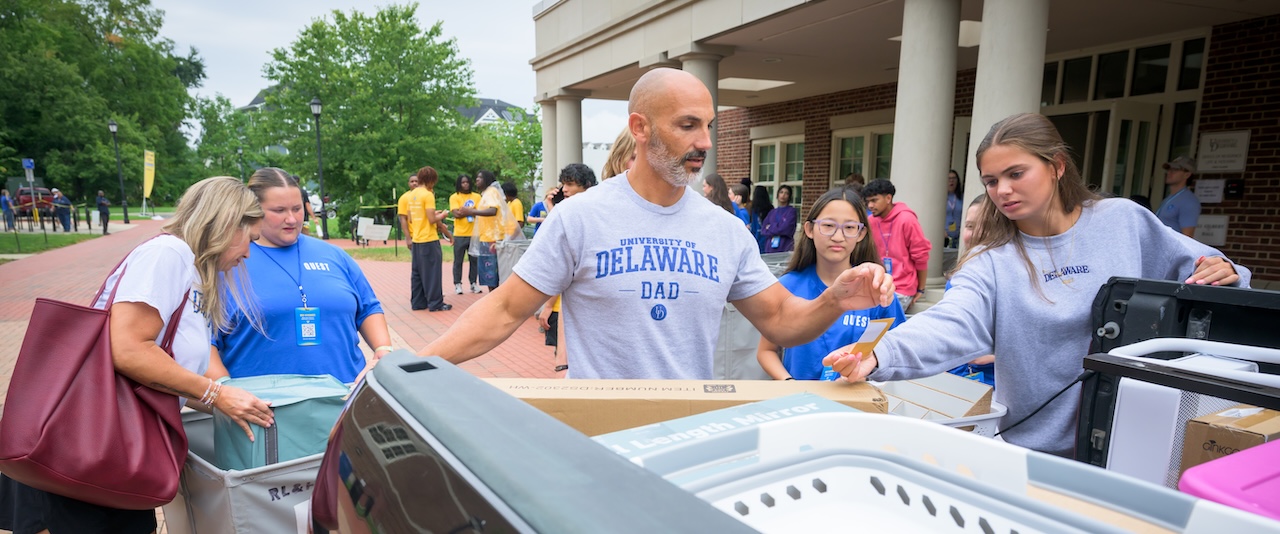 A UD dad unloads a car during move-in as first-year students and their families arrive on campus on Saturday, Aug. 22.