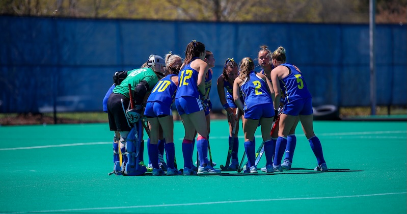 field hockey players in huddle