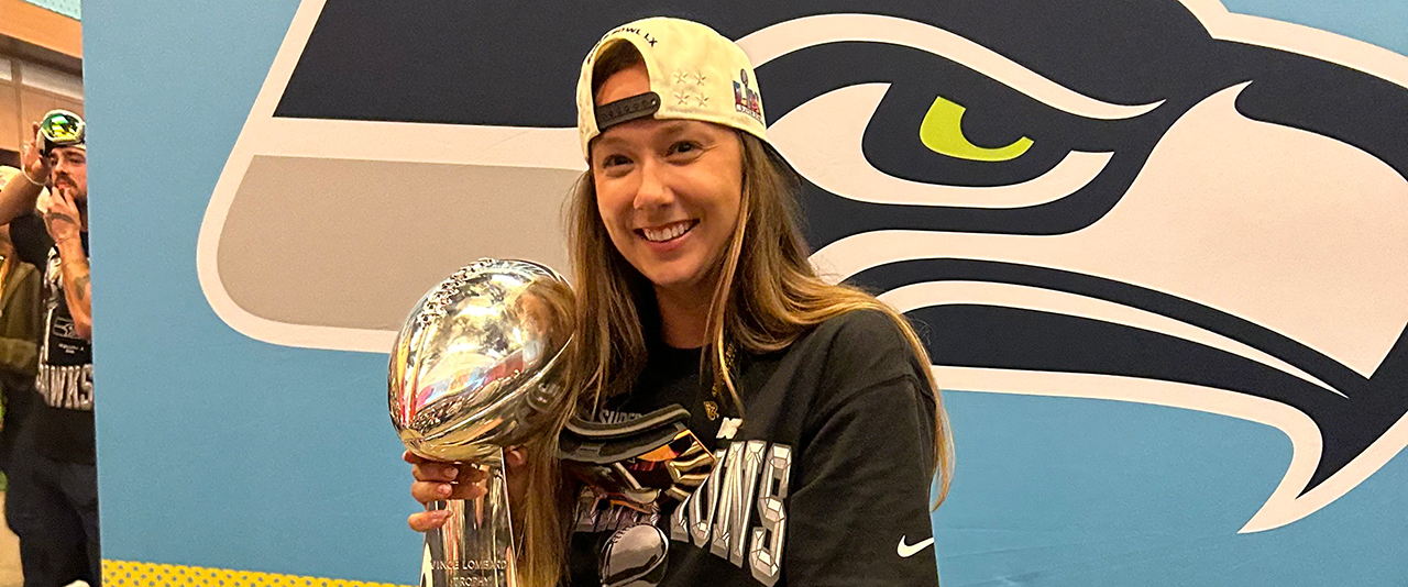 UD alumna Jennifer Witt, a seasonal athletic training intern for the Seattle Seahawks, holds the Lombardi Trophy after the Seahawks won Super Bowl LX.