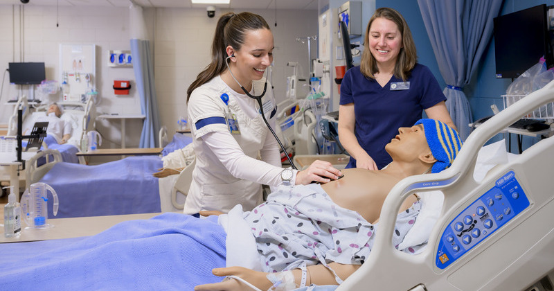 DAISY Award winners in action: Madison Wirchansky (left) hones her skills on a high-fidelity manikin as Assistant Professor of Nursing Michelle DePhillips observes in UD’s Simulation Lab in McDowell Hall.