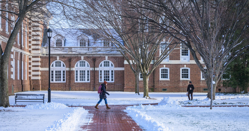 A University of Delaware student walks a shoveled path on UD’s Newark Campus following a winter storm in January 2025.