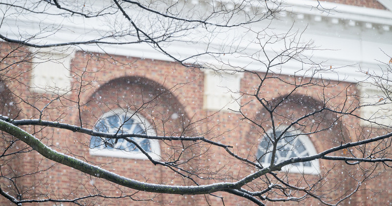 Snow begins to fall outside of Mitchell Hall on the University’s Newark Campus in December 2025.