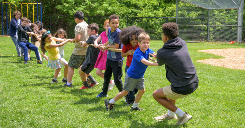 Children play tug-of-war in a summer camp at The College School, housed in UD’s College of Education and Human Development. 