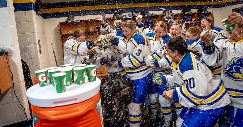 The groundbreaking Division 1 women’s ice hockey team at the University of Delaware, seen here dumping water on Coach Allision Coomey after the first win of the season, has much to celebrate.