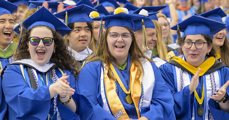 Eryn Cohen, Ellen Lynn and Julia Diamond, honors graduates from the Class of 2025, celebrate at the 2025 University of Delaware Commencement at Delaware Stadium.
